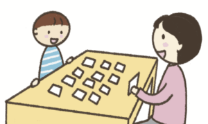 カードを使って遊んでいる指導者と子ども
